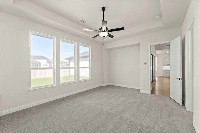 3304 Andesite Rd, Mckinney, TX 75071 - unfurnished bedroom featuring carpet floors, baseboards, a tray ceiling, and ceiling fan
