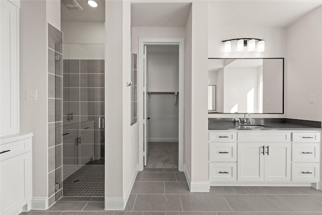 3304 Andesite Rd, Mckinney, TX 75071 - full bath featuring a shower stall, vanity, tile patterned flooring, baseboards, and a spacious closet