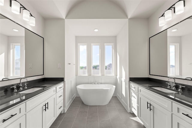 3304 Andesite Rd, Mckinney, TX 75071 - full bath with a soaking tub, recessed lighting, two vanities, and tile patterned floors