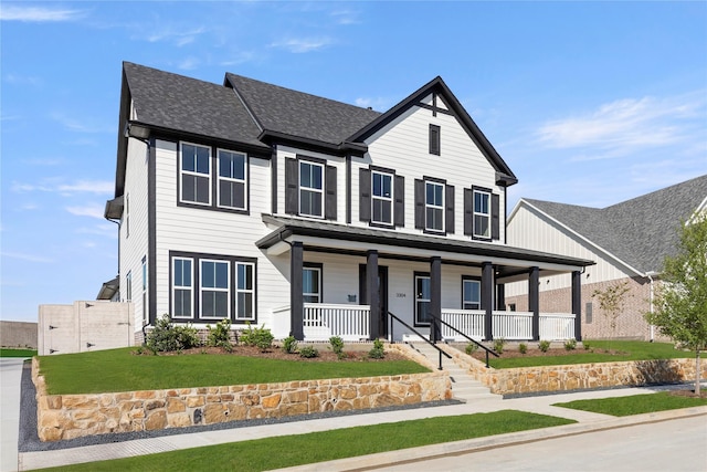 3304 Andesite Rd, Mckinney, TX 75071 - view of front facade with a porch, a front lawn, and roof with shingles