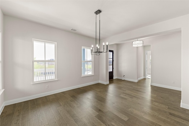 3304 Andesite Rd, Mckinney, TX 75071 - unfurnished dining area featuring dark wood finished floors, baseboards, and a chandelier