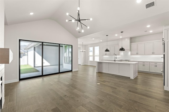 3304 Andesite Rd, Mckinney, TX 75071 - kitchen with a chandelier, recessed lighting, white cabinets, lofted ceiling, and tasteful backsplash