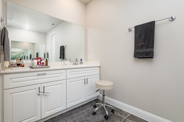 bathroom with tile patterned flooring and vanity