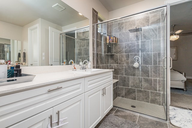 bathroom with ceiling fan, vanity, and an enclosed shower