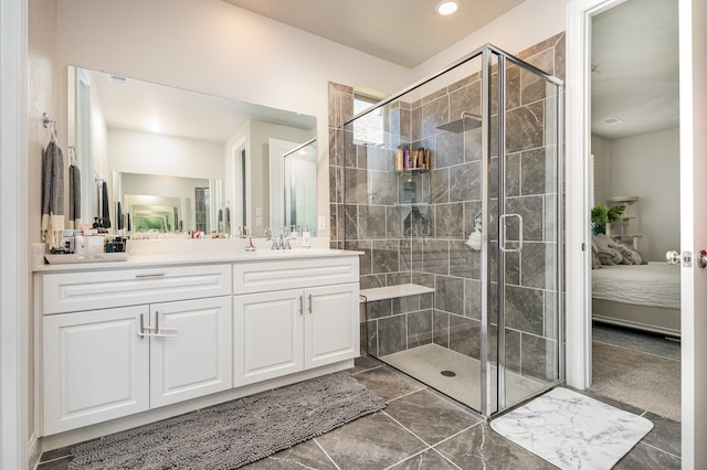 bathroom with vanity and a shower with door