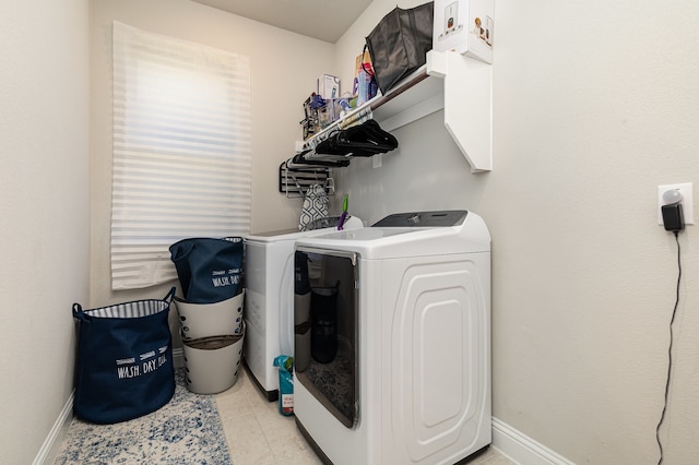 washroom featuring light tile patterned flooring and washer and dryer