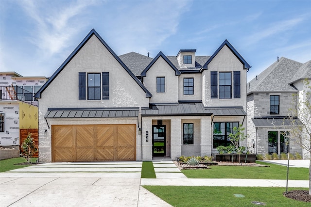 view of front of property featuring a front lawn and a garage