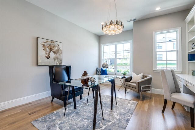 home office featuring a notable chandelier and light wood-type flooring