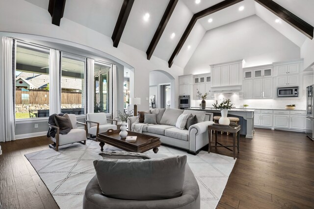 living room featuring beamed ceiling, high vaulted ceiling, and light wood-type flooring