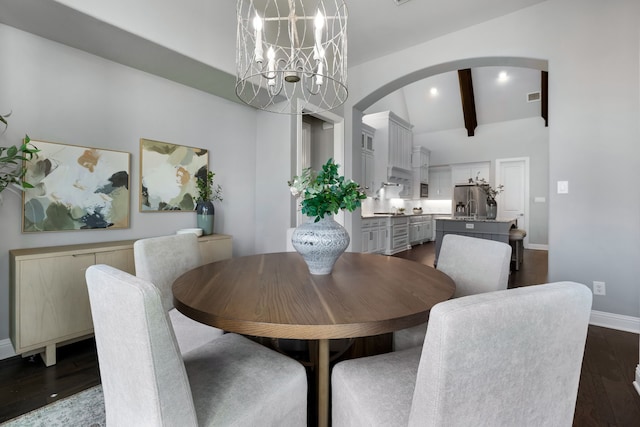 dining space with beamed ceiling, dark hardwood / wood-style flooring, and a notable chandelier