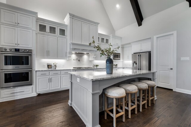 kitchen with white cabinets, a center island, and stainless steel appliances