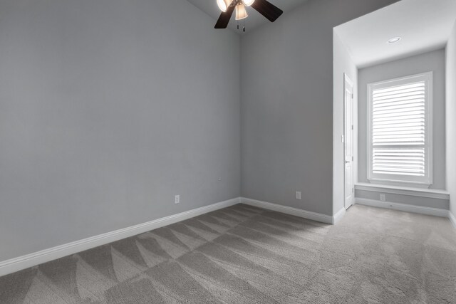 empty room featuring ceiling fan and carpet floors