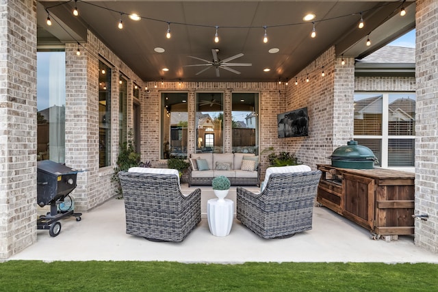 view of patio with area for grilling, ceiling fan, an outdoor kitchen, and an outdoor hangout area