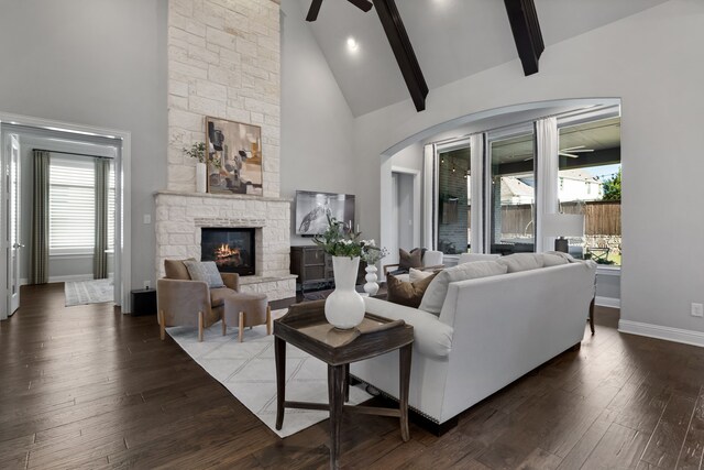 living room with a fireplace, a wealth of natural light, dark wood-type flooring, and ceiling fan