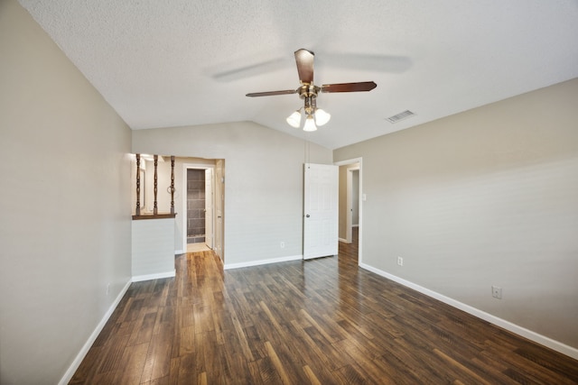 empty room featuring vaulted ceiling, ceiling fan, a textured ceiling, and dark hardwood / wood-style floors