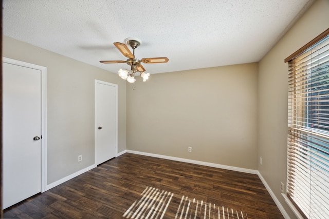 unfurnished room with a textured ceiling, ceiling fan, and dark wood-type flooring