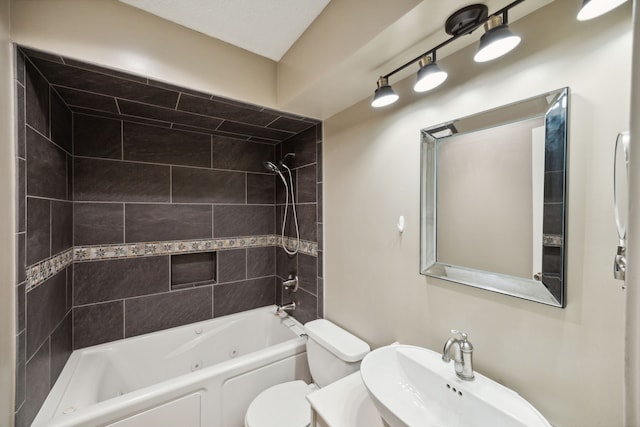 full bathroom featuring toilet, tiled shower / bath, and sink