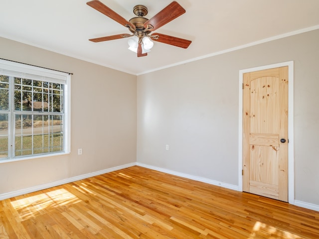 empty room featuring crown molding, light hardwood / wood-style flooring, and ceiling fan