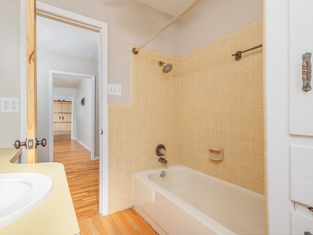 bathroom with vanity, tiled shower / bath, and hardwood / wood-style flooring