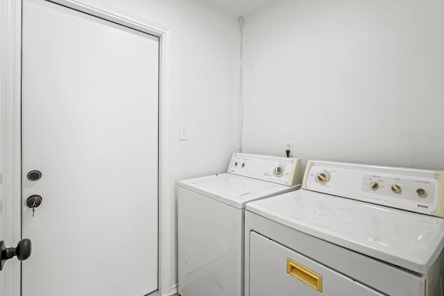 laundry area with washing machine and clothes dryer