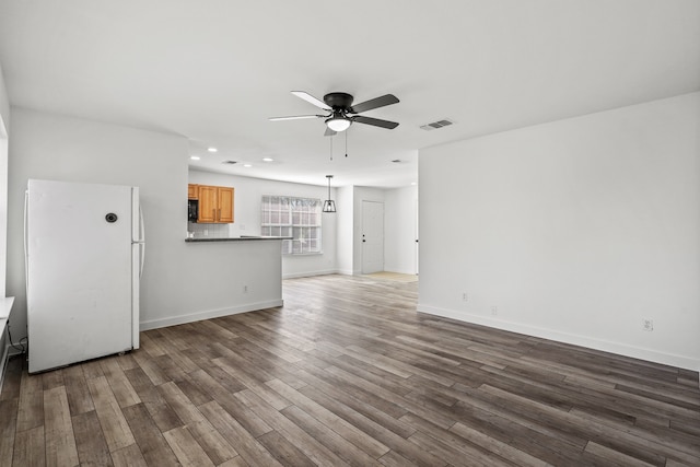 unfurnished living room featuring ceiling fan and wood-type flooring