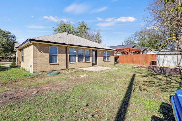 back of property featuring a lawn and a patio area