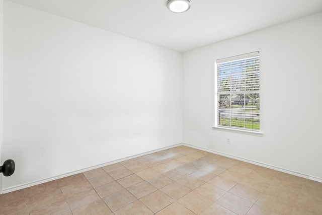 spare room with light tile patterned floors