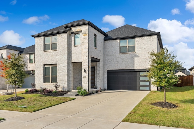 view of front of house featuring a front lawn and a garage