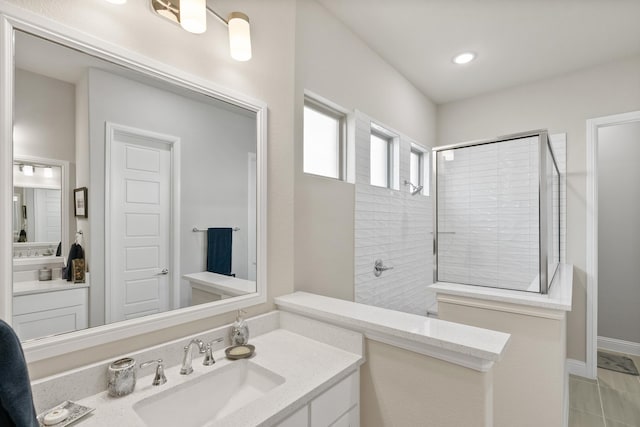 bathroom with recessed lighting, walk in shower, and vanity