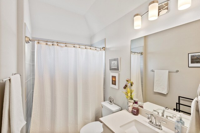 bathroom with vanity, a shower with shower curtain, and toilet