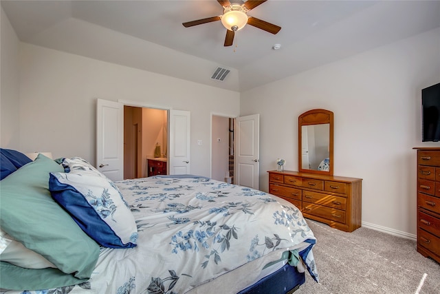 carpeted bedroom with ensuite bath, ceiling fan, and lofted ceiling