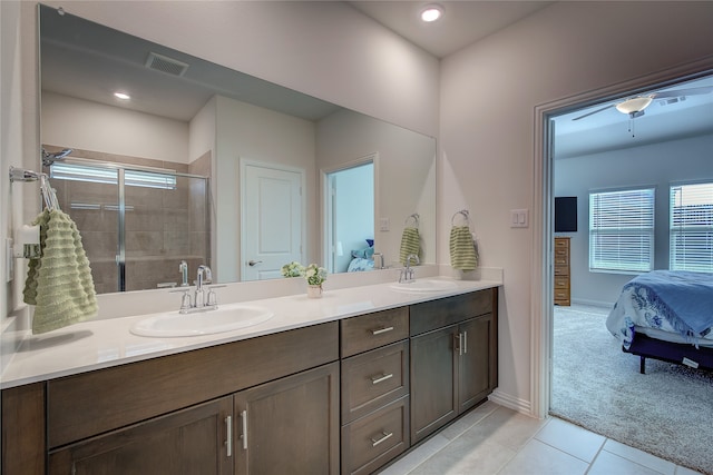 bathroom featuring tile patterned floors, vanity, ceiling fan, and walk in shower