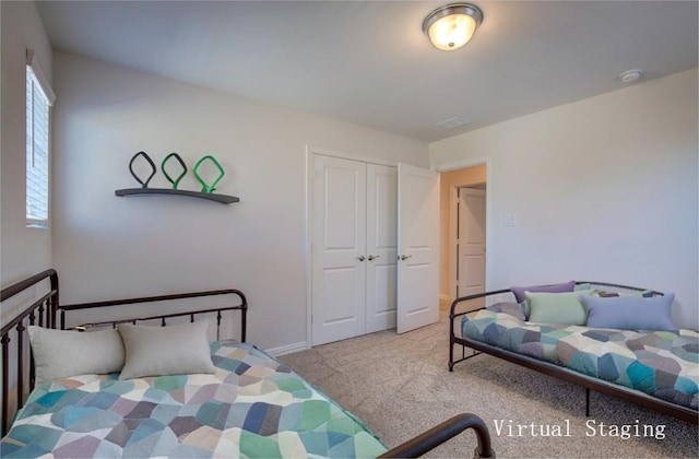 bedroom with light carpet and a closet