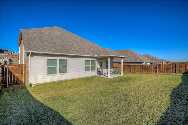 back of property with a patio and a lawn