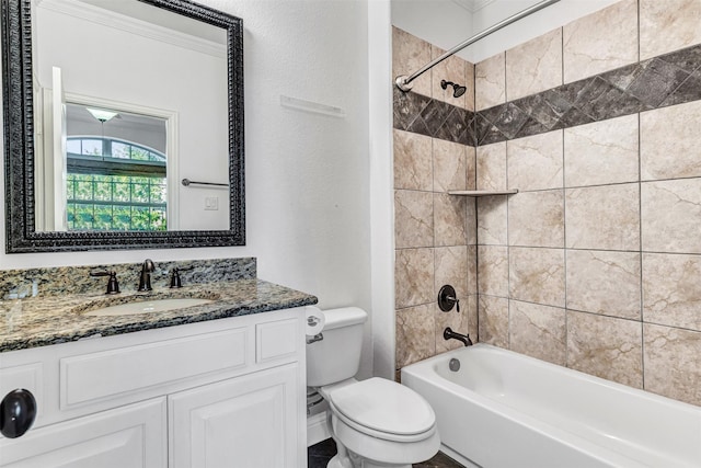 full bathroom with vanity, tiled shower / bath combo, and toilet