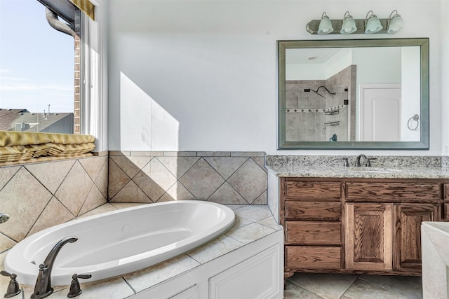 bathroom featuring tile patterned floors, vanity, and separate shower and tub