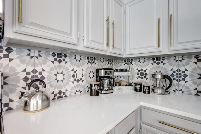 kitchen with white cabinets and backsplash