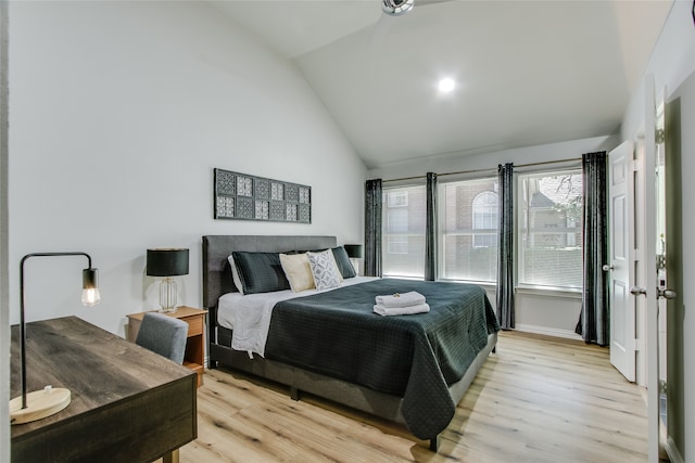 bedroom featuring light wood-type flooring and lofted ceiling