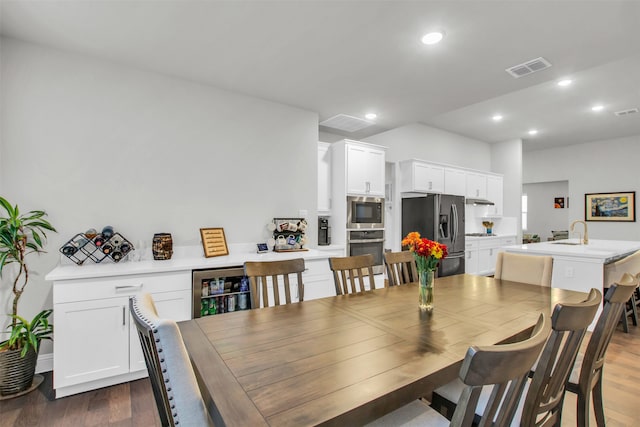 dining room with wine cooler and dark hardwood / wood-style floors