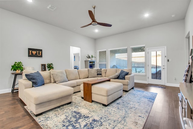 living room with ceiling fan and dark hardwood / wood-style floors