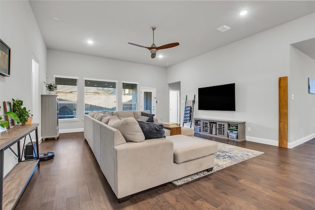 living room with ceiling fan and dark wood-type flooring