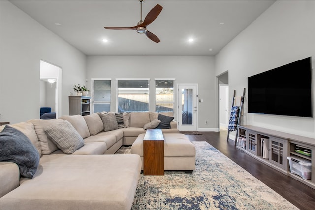 living room featuring dark hardwood / wood-style flooring and ceiling fan