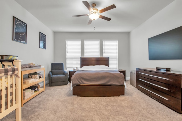 bedroom with light colored carpet and ceiling fan