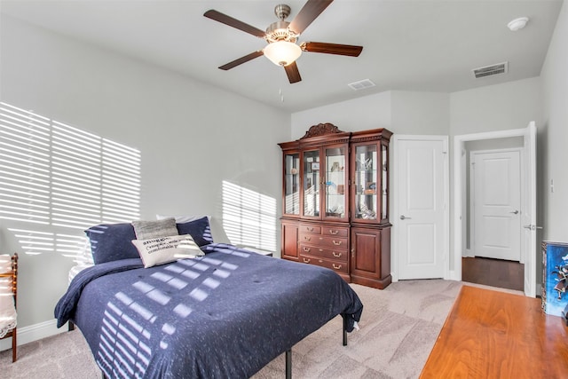 bedroom with light hardwood / wood-style flooring and ceiling fan