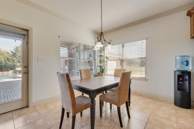 dining room with crown molding, light tile patterned floors, and a chandelier