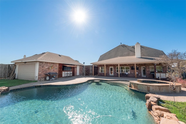 view of swimming pool with area for grilling, a patio area, and an in ground hot tub