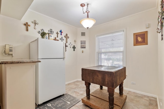 tiled dining room featuring ornamental molding