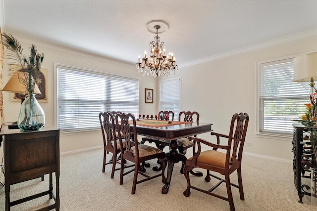 dining area featuring a notable chandelier, ornamental molding, and light carpet