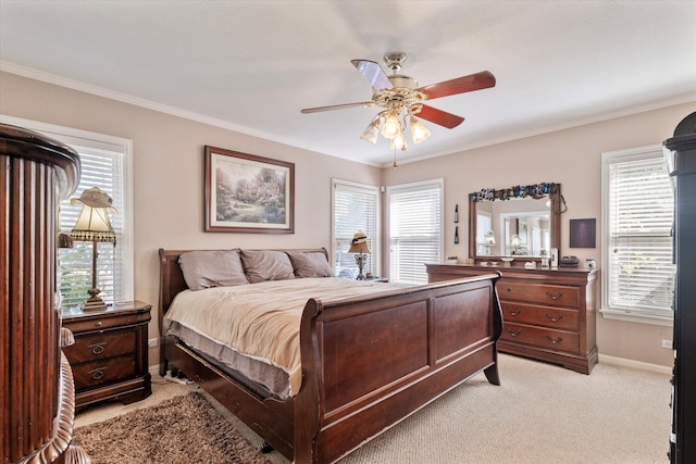 carpeted bedroom featuring ceiling fan and crown molding