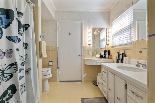 bathroom with vanity, toilet, tile walls, and ornamental molding